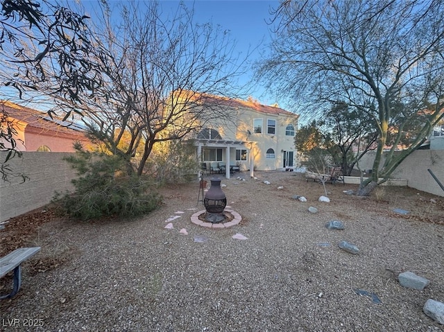 view of yard with fence and a fire pit