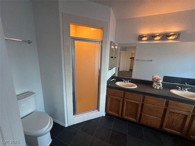 bathroom with tile patterned flooring, a sink, toilet, and a shower stall