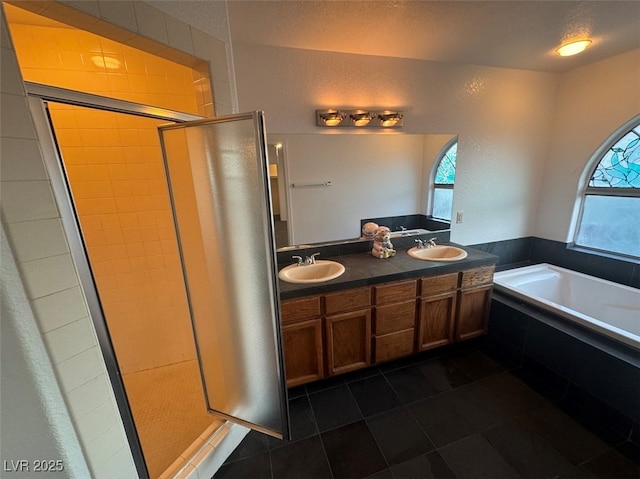 bathroom featuring a sink, a bath, and a healthy amount of sunlight