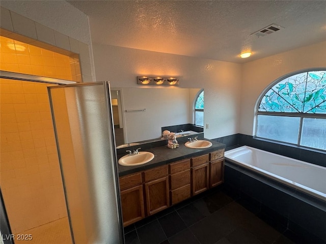 full bath featuring a bath, a stall shower, visible vents, and a sink