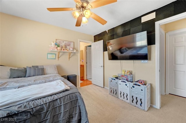 bedroom featuring light colored carpet, ceiling fan, and baseboards