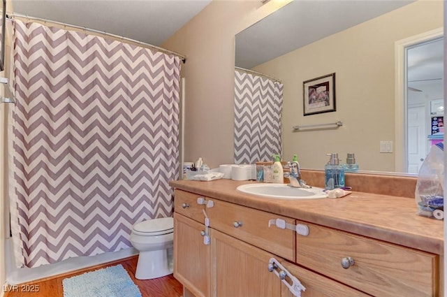 full bathroom with a shower with curtain, vanity, toilet, and wood finished floors