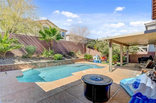 view of pool with a fire pit, a patio area, a fenced backyard, and a fenced in pool