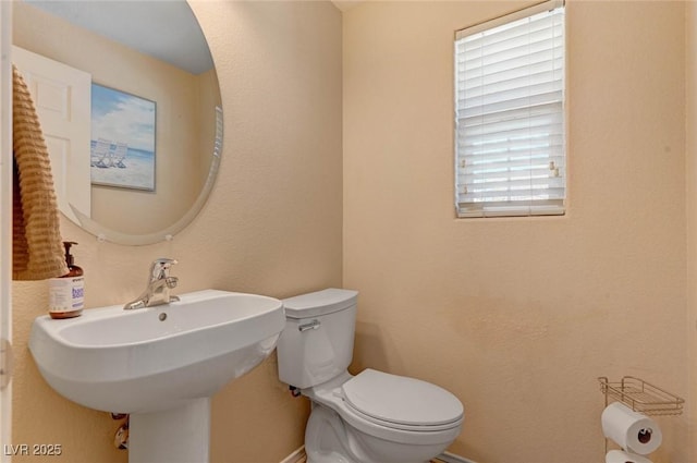 bathroom featuring toilet and a sink