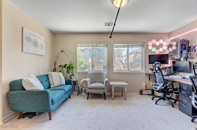 office space with carpet flooring, visible vents, and baseboards