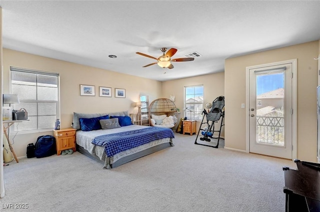 bedroom featuring light colored carpet, a ceiling fan, baseboards, visible vents, and access to outside