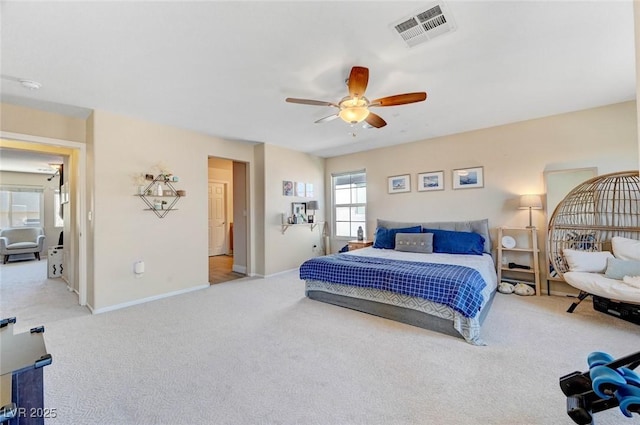 bedroom with visible vents, ceiling fan, light carpet, and baseboards