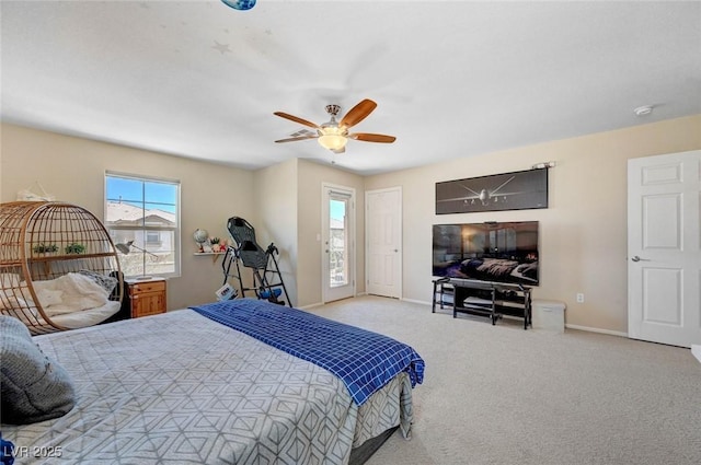 bedroom featuring a ceiling fan, light colored carpet, and baseboards