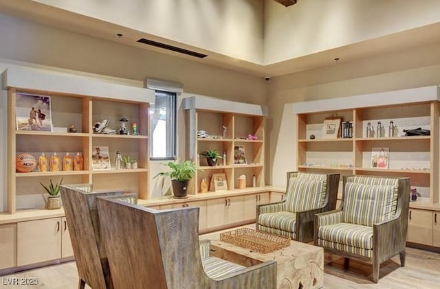 sitting room featuring light wood finished floors and visible vents