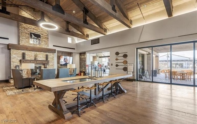 dining room with high vaulted ceiling, beamed ceiling, wooden ceiling, and wood finished floors