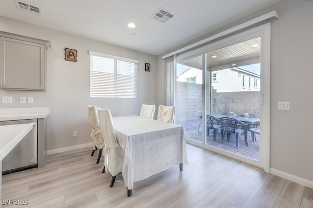 dining room featuring light wood-style flooring, visible vents, baseboards, and recessed lighting