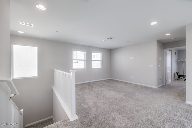 unfurnished room featuring recessed lighting, baseboards, visible vents, and light colored carpet