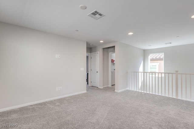 empty room with recessed lighting, visible vents, light carpet, and baseboards