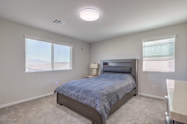 bedroom featuring light carpet, multiple windows, and visible vents