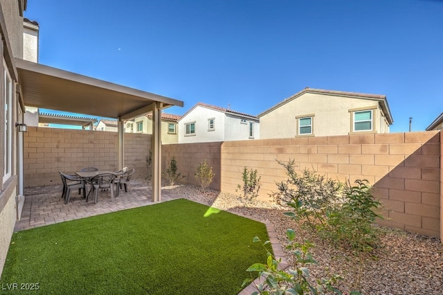 view of yard featuring a patio area and a fenced backyard