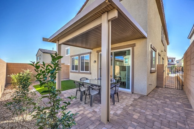 view of patio / terrace featuring outdoor dining space, a gate, and a fenced backyard