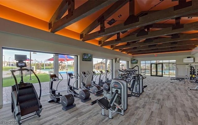 workout area featuring high vaulted ceiling, carpet, and a wall mounted air conditioner