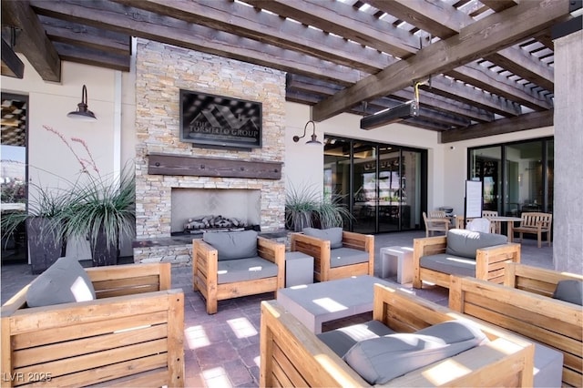 view of patio / terrace featuring an outdoor living space with a fireplace and a pergola