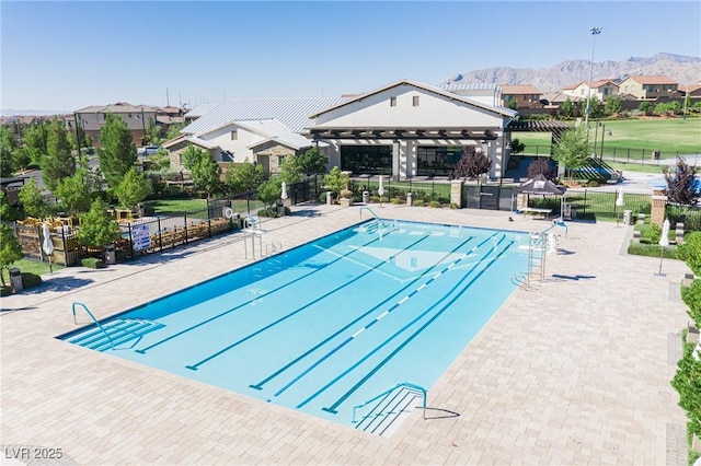 pool with a gazebo, a patio area, a mountain view, fence, and a residential view