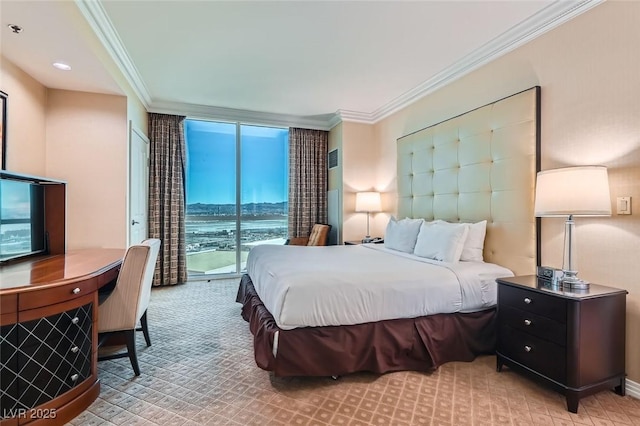 bedroom featuring access to outside, ornamental molding, and a wall of windows