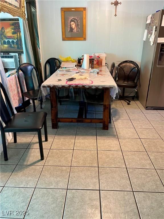 dining space with light tile patterned floors and cooling unit