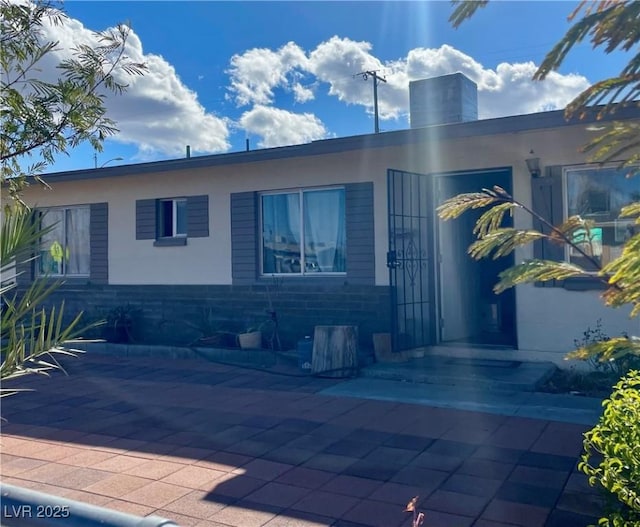 view of front of property with a patio area and stucco siding