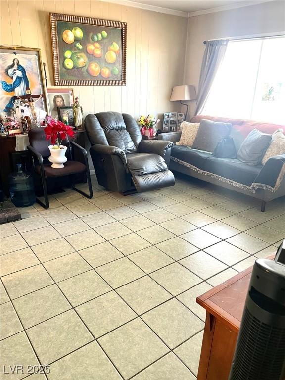 living area with light tile patterned floors and ornamental molding