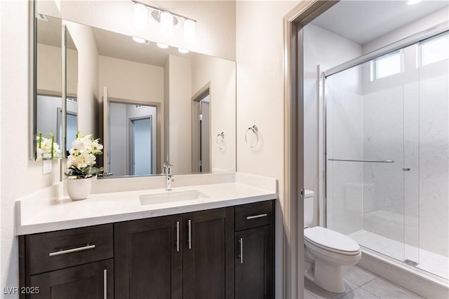 full bathroom featuring toilet, a stall shower, tile patterned floors, and vanity