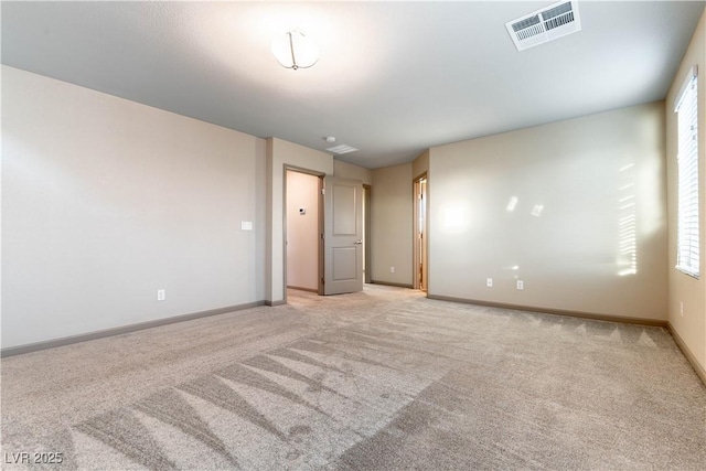 unfurnished room featuring light carpet, visible vents, and baseboards