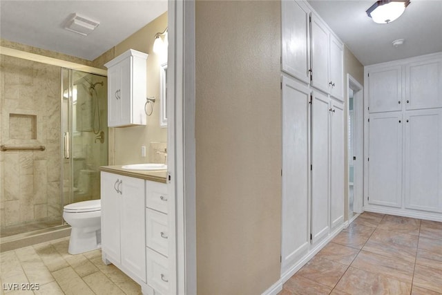 full bath featuring visible vents, a stall shower, vanity, and toilet