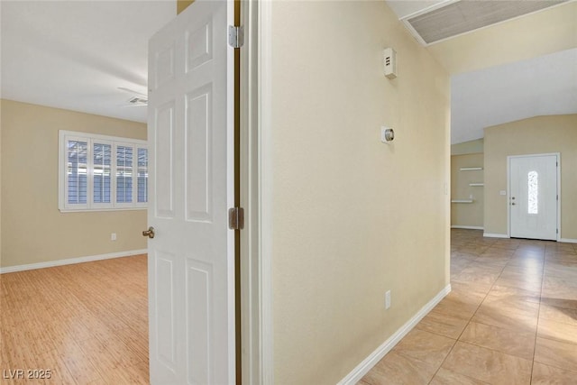 hallway featuring plenty of natural light, visible vents, and baseboards