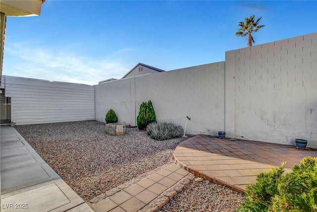 view of yard with a patio area and a fenced backyard