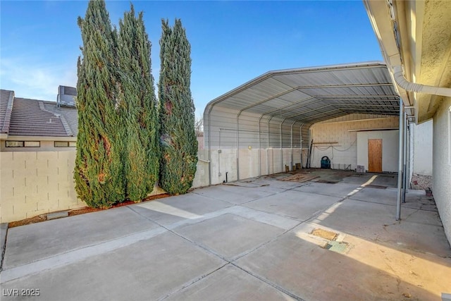 view of parking featuring a carport, fence, and driveway