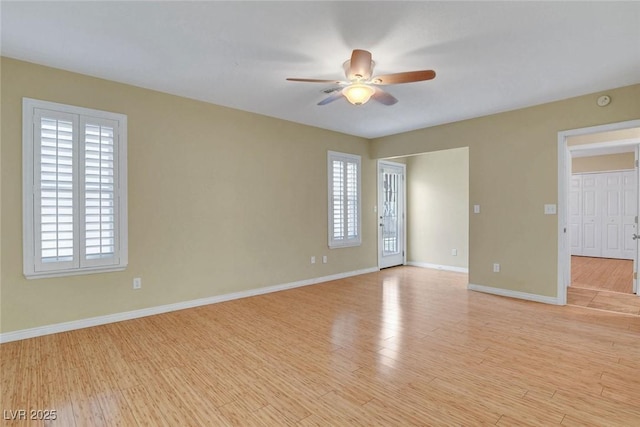 unfurnished room featuring light wood-type flooring, ceiling fan, and baseboards