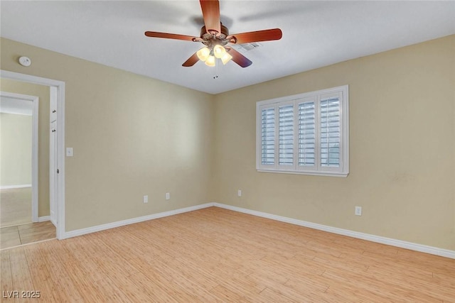 unfurnished room featuring a ceiling fan, light wood-type flooring, and baseboards