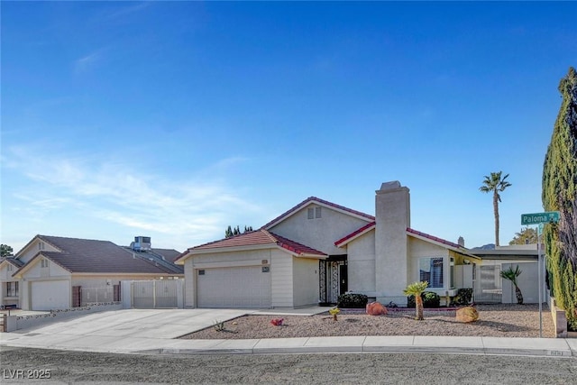 view of front of property featuring a garage, concrete driveway, and stucco siding