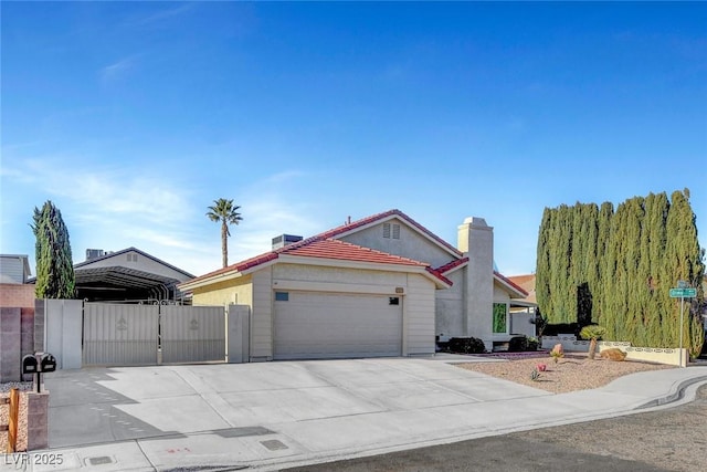 view of front facade with concrete driveway, an attached garage, and a tiled roof