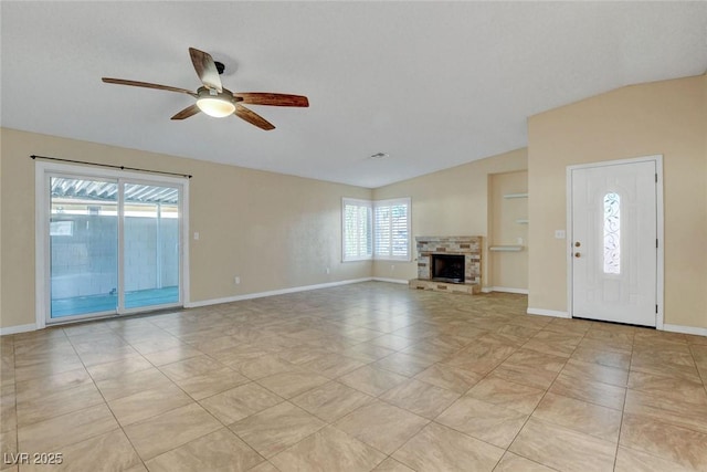 unfurnished living room featuring lofted ceiling, a stone fireplace, light tile patterned floors, and baseboards