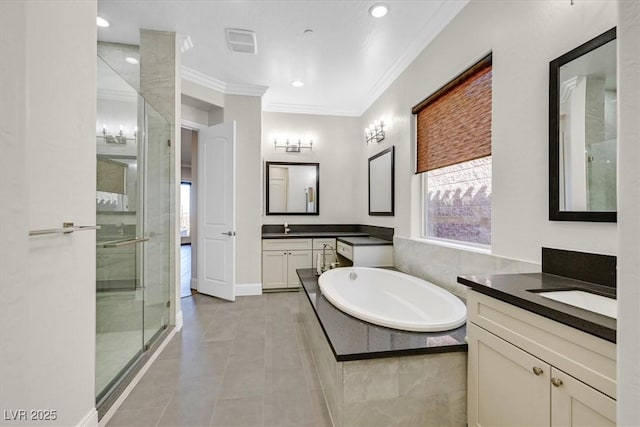 full bathroom featuring a stall shower, tile patterned floors, a garden tub, crown molding, and two vanities