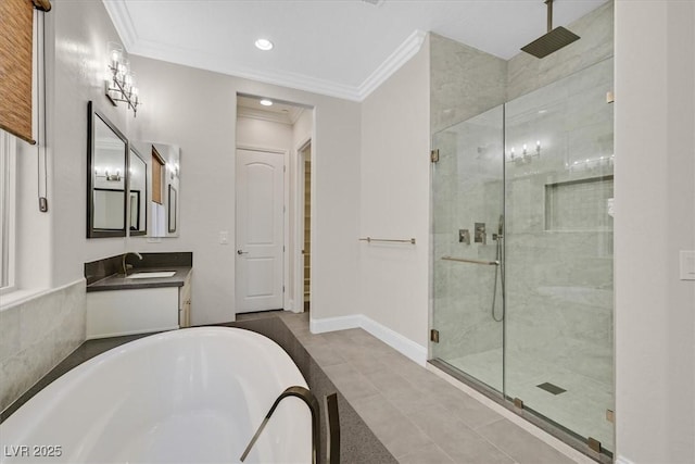 full bathroom featuring ornamental molding, a stall shower, tile patterned flooring, a freestanding tub, and baseboards