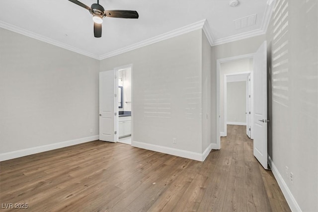 unfurnished bedroom featuring crown molding, visible vents, ensuite bath, light wood-type flooring, and baseboards