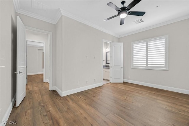 unfurnished bedroom with baseboards, visible vents, ensuite bath, ornamental molding, and light wood-style floors