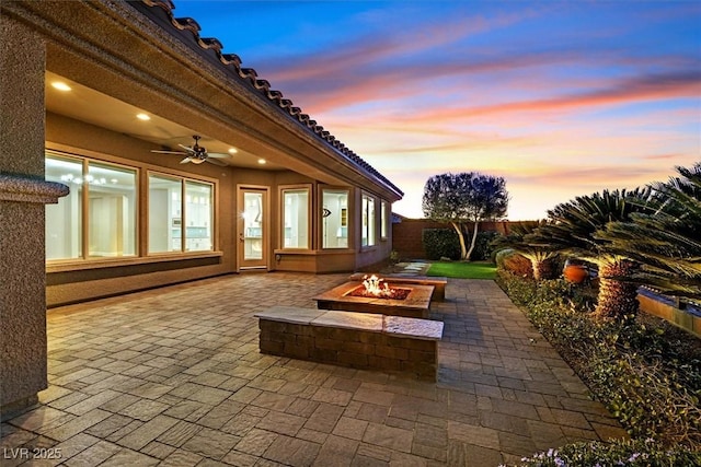 view of patio / terrace featuring an outdoor fire pit and fence