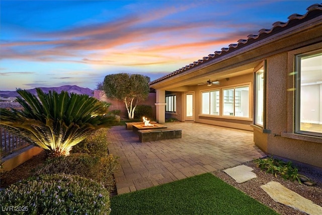 view of patio featuring an outdoor fire pit and a ceiling fan