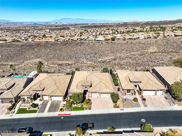 birds eye view of property with a mountain view and a residential view