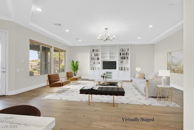 living area with light wood finished floors, baseboards, visible vents, an inviting chandelier, and recessed lighting