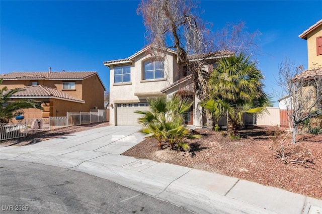 view of front of house featuring a garage, driveway, fence private yard, and stucco siding