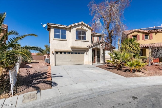 mediterranean / spanish-style home featuring driveway, a garage, a tiled roof, fence, and stucco siding