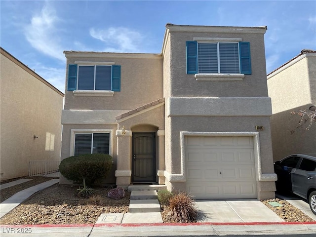 townhome / multi-family property featuring driveway, an attached garage, and stucco siding