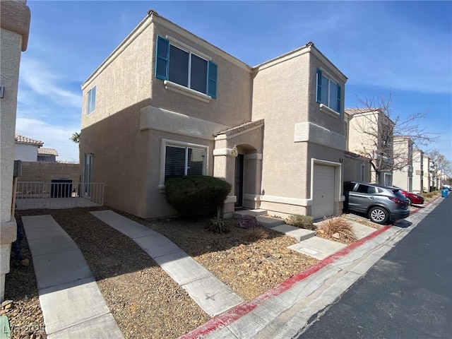 view of front of home with central AC unit, an attached garage, fence, and stucco siding